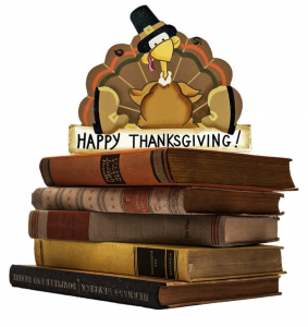 Happy Thanksgiving; a Turkey sitting on a stack of books.