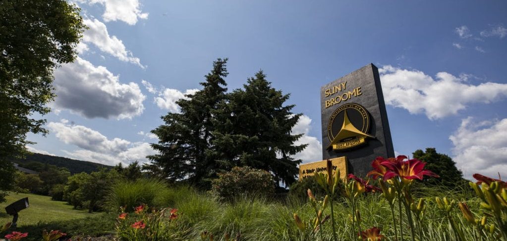 SUNY Broome monolith with spring flowers