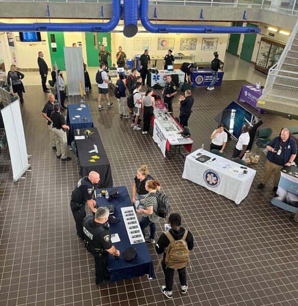 Criminal Justice & Emergency Services (CJES) Career Preparedness EXPO - Tables & people viewed from above