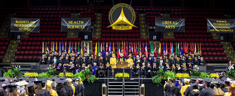 SUNY Broome graduation at the arena. View from the back towards the stage with the dignataries.