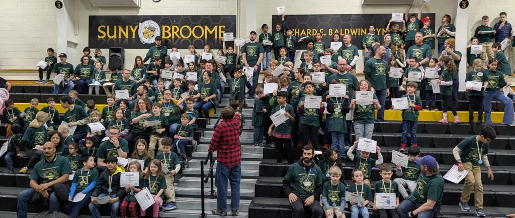 Lego Explore Expo: All the students/teams in the bleachers showing their certificates