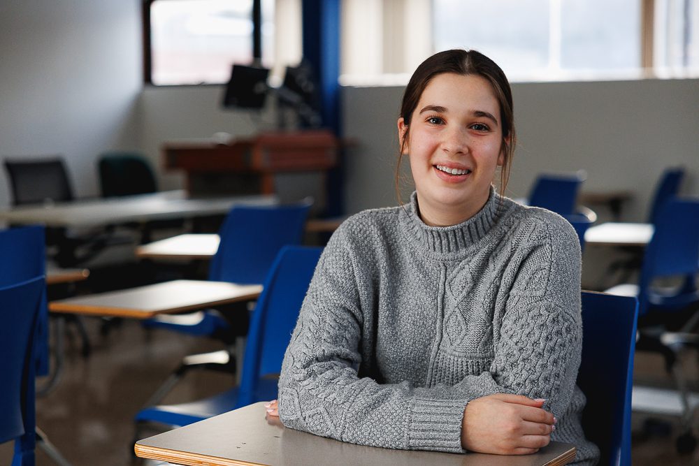 Alex Lisio sits in a business classroom. 