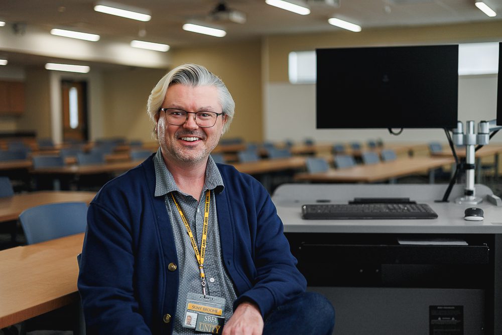 Andrew Robertshaw sits in a classroom. 