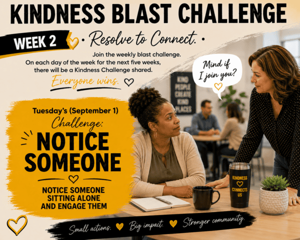 Kindness Blast Challenge Week2: Resolve to Connect. Tuesday Sept. 1 challenge is to Notice Someone sitting alone and engage them in conversation. A woman is sitting alone at a desk and another woman stops by and says "Mind if I join you". Small actions, big impact, stronger community.