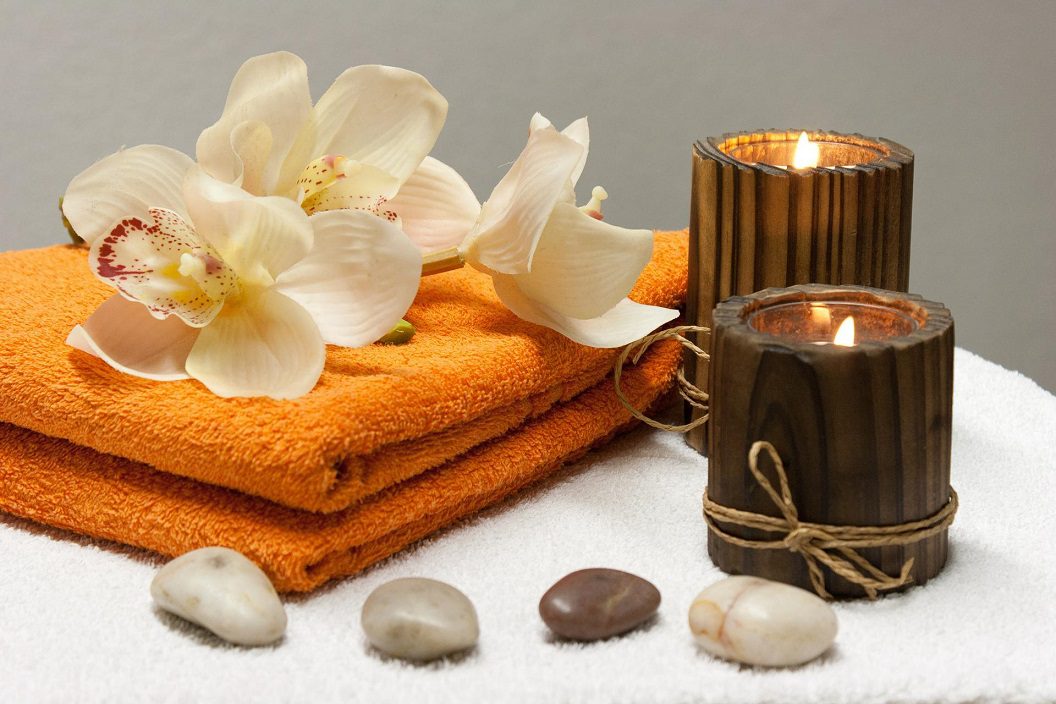 spa time with towels, candles and orchids