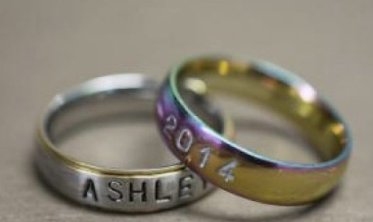 Two rings. One etched with Ashley, the other etched iwth 2014.