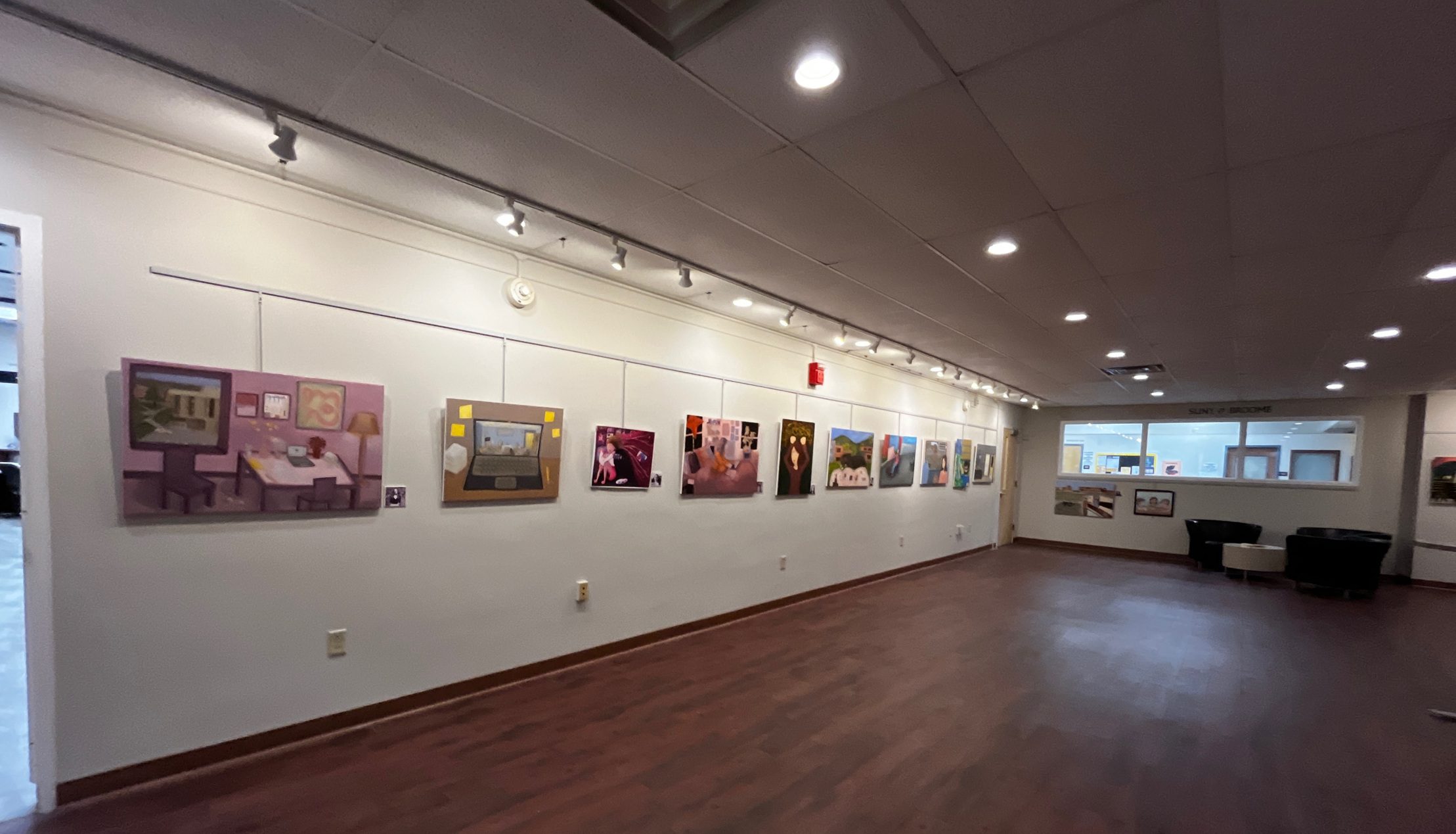 Image of artwork from Student Life hanging on the walls in the Gallery at SUNY Broome.